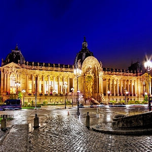 Beautiful sunset view of the Louvre Palace with its historic architecture and glass pyramid in Paris, France.