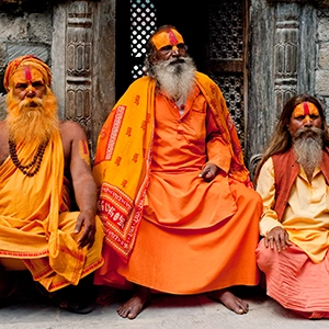 Scenic view of the historic ghats of Varanasi, India, with steps leading to the Ganges River and colorful buildings along the riverbank.