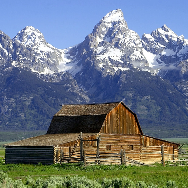 Scenic view of majestic mountain peaks and lush green landscape at Grand Teton National Park